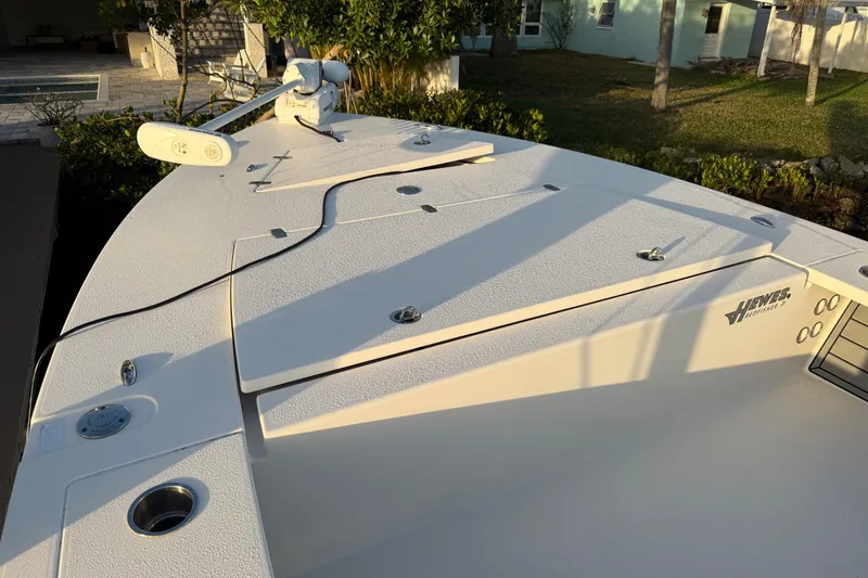 Slide: The Image of 2021 Hewes Redfisher 21 boat deck with trolling motor, in a sunny outdoor setting. - 3