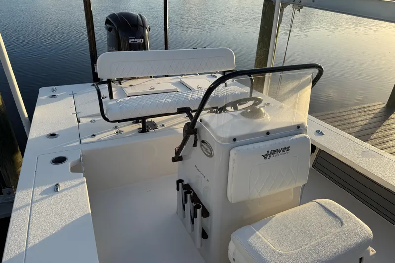 Slide: The Image of 2021 Hewes Redfisher 21 boat with Yamaha 250 engine, docked on calm water. - 6