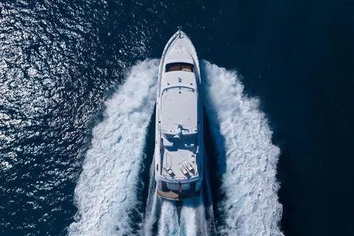 Slide: The Image of 2005 Hatteras 80 Motor Yacht cruising on open blue sea, aerial view. - 10