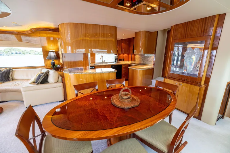Slide: The Image of Luxurious interior of 2005 Hatteras 80 Motor Yacht with elegant seating and wood accents. - 18