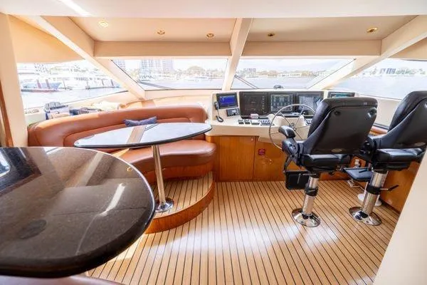 Slide: The Image of Luxurious interior of 2005 Hatteras 80 Motor Yacht with elegant dining area and panoramic windows. - 22
