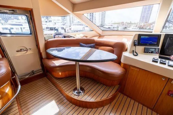 Slide: The Image of Luxurious interior of 2005 Hatteras 80 Motor Yacht with leather seating and wooden accents. - 26