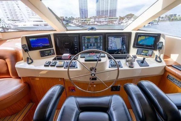 Slide: The Image of Luxurious interior of 2005 Hatteras 80 Motor Yacht with leather seating and navigation equipment. - 27
