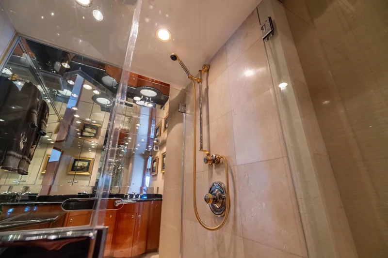 Slide: The Image of Luxurious bedroom interior of 2005 Hatteras 80 Motor Yacht with elegant decor and porthole windows. - 34