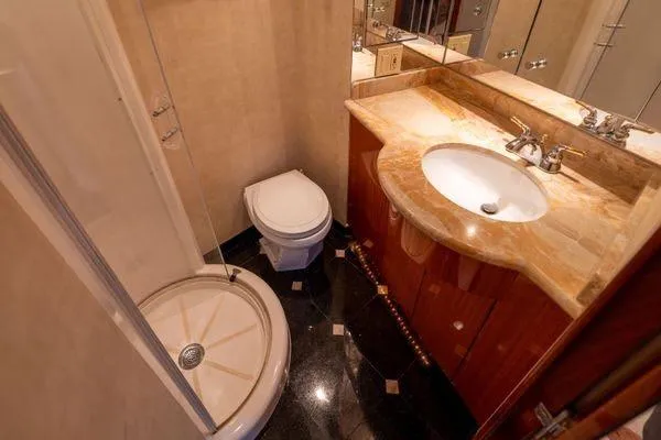 Slide: The Image of Luxurious bathroom in 2005 Hatteras 80 Motor Yacht with elegant wood cabinetry and black fixtures. - 38