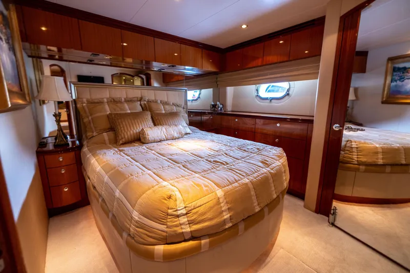 Slide: The Image of Luxurious bedroom in 2005 Hatteras 80 Motor Yacht with elegant bedding and wood cabinetry. - 43