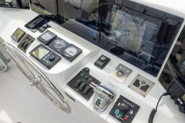 Slide: The Image of Helm of 2005 Hatteras 80 Motor Yacht with advanced navigation systems and luxurious seating. - 51