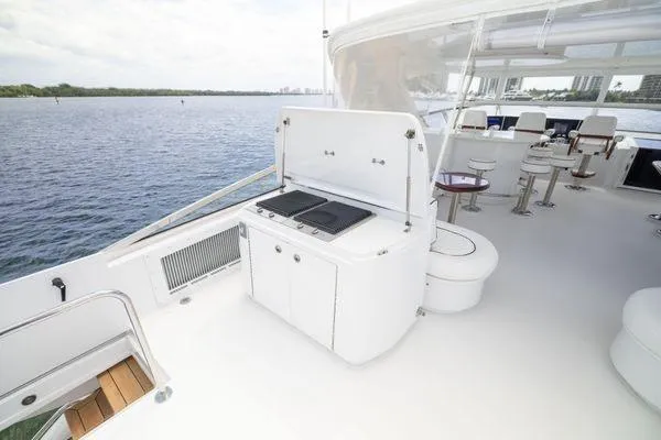 Slide: The Image of Luxurious 2005 Hatteras 80 Motor Yacht interior with elegant seating and polished tables. - 57