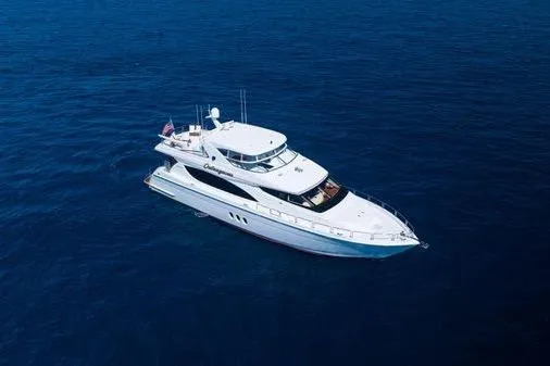 Slide: The Image of Luxurious 2005 Hatteras 80 Motor Yacht deck with elegant seating and scenic water views. - 60