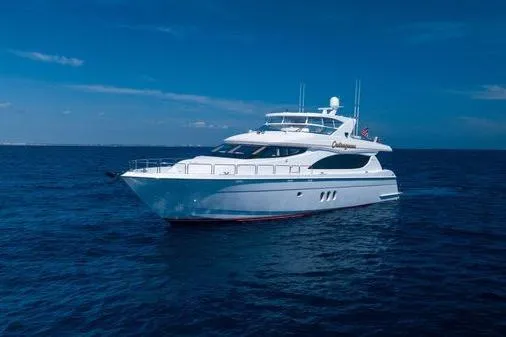 Slide: The Image of Luxurious 2005 Hatteras 80 Motor Yacht deck with sun loungers and American flag. - 61