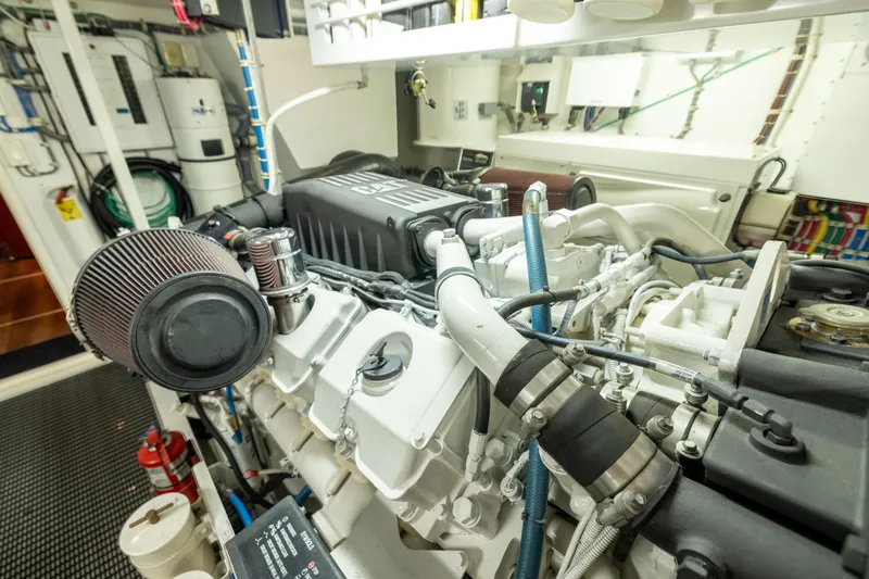 Slide: The Image of Engine room of 2005 Hatteras 80 Motor Yacht, showcasing detailed machinery and components. - 66