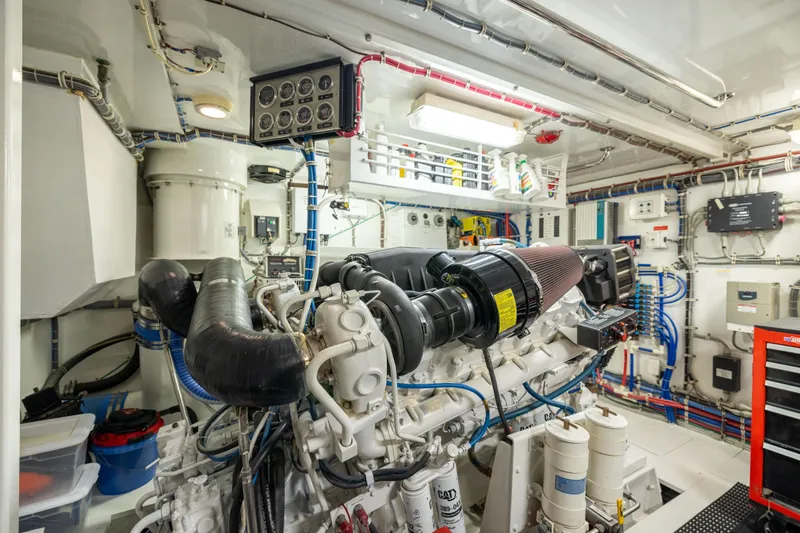 Slide: The Image of Engine room of 2005 Hatteras 80 Motor Yacht, featuring complex machinery and wiring. - 67
