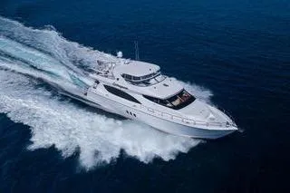 Slide: The Image of 2005 Hatteras 80 Motor Yacht cruising on a sunny day, surrounded by calm waters. - 7