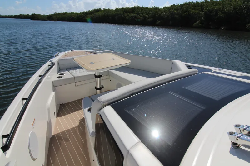 Slide: The Image of 2025 Saxdor 400 GTS boat with seating and table on a sunny lake. - 10