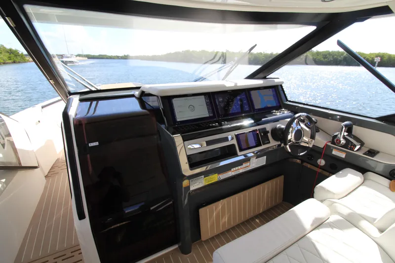 Slide: The Image of Helm of 2025 Saxdor 400 GTS yacht with modern navigation equipment and luxurious seating. - 14