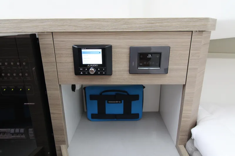 Slide: The Image of Control panel and storage area inside 2025 Saxdor 400 GTS boat cabin. - 19