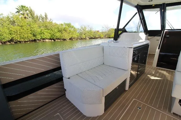 Slide: The Image of 2025 Saxdor 400 GTS boat interior with white seating and sleek design. - 22