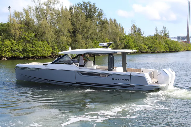 Slide: The Image of 2025 Saxdor 400 GTS cruising on a scenic waterway with lush greenery. - 33