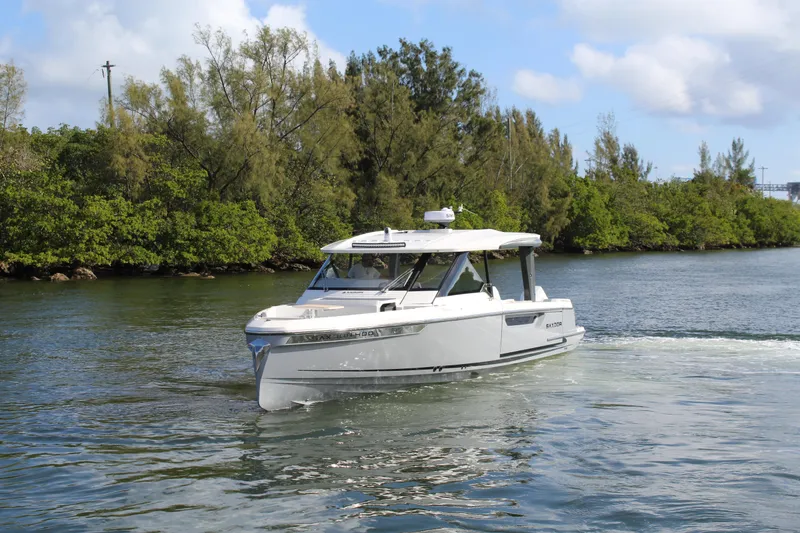 Slide: The Image of 2025 Saxdor 400 GTS cruising on a scenic waterway with lush greenery. - 34