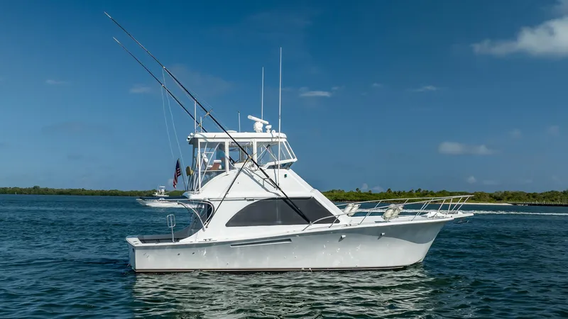 Slide: The Image of 1991 Jersey 42 Convertible Sportfisherman boat on calm water under clear blue sky. - 9