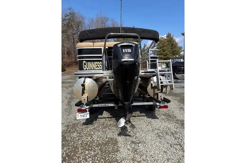 Slide: The Image of 2018 Lowe SS 210 pontoon boat with outboard motor, parked on gravel. - 4
