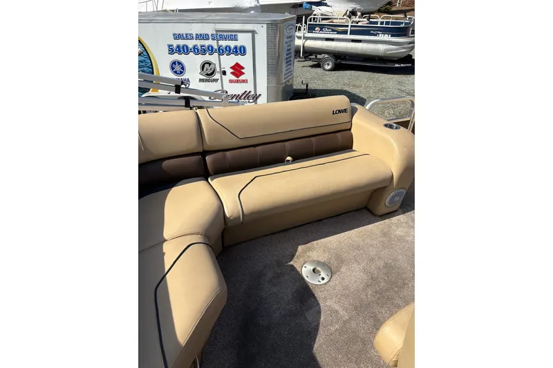 Slide: The Image of 2018 Lowe SS 210 boat interior with beige seating and carpet flooring. - 6