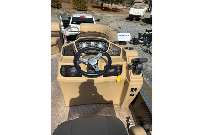 Slide: The Image of 2018 Lowe SS 210 boat dashboard with steering wheel and control panel. - 8