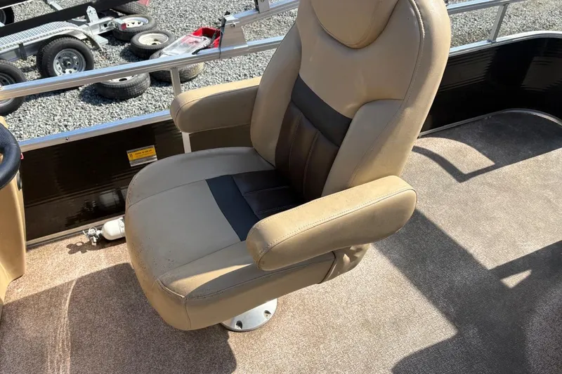 Slide: The Image of Beige captain's chair on 2018 Lowe SS 210 boat, with trailer in background. - 9