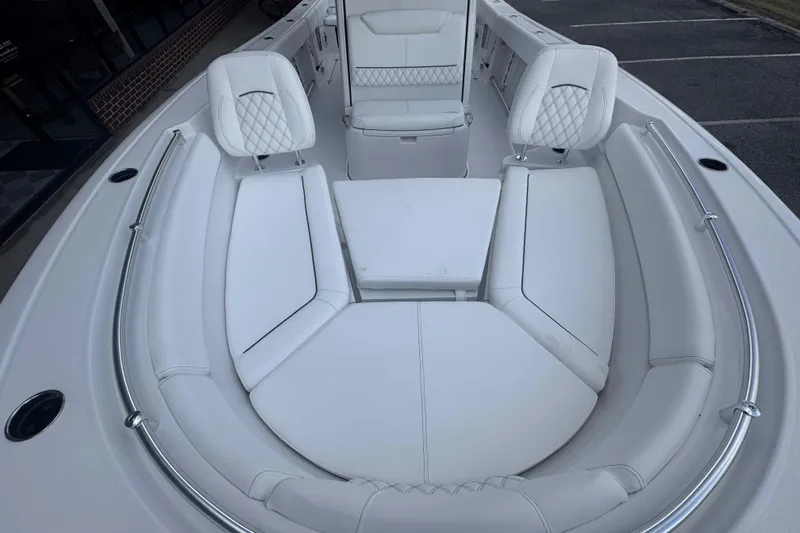 Slide: The Image of 2026 Sportsman Heritage 261 Center Console boat with luxurious white seating arrangement. - 14