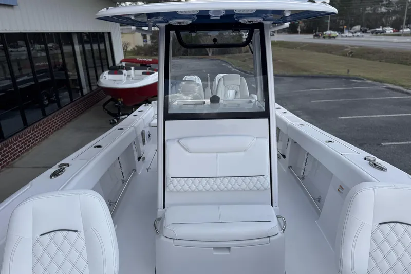 Slide: The Image of 2026 Sportsman Heritage 261 Center Console boat with sleek white interior design. - 15