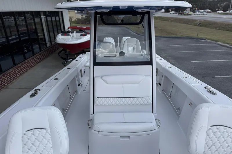 Slide: The Image of 2026 Sportsman Heritage 261 Center Console boat with sleek white interior design. - 16