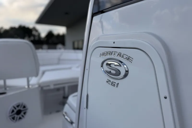 Slide: The Image of 2026 Sportsman Heritage 261 Center Console boat, close-up of logo and seating area. - 17