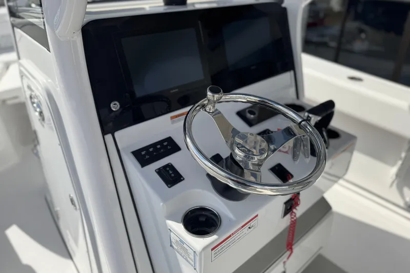 Slide: The Image of 2026 Sportsman Heritage 261 Center Console steering wheel and control panel. - 18