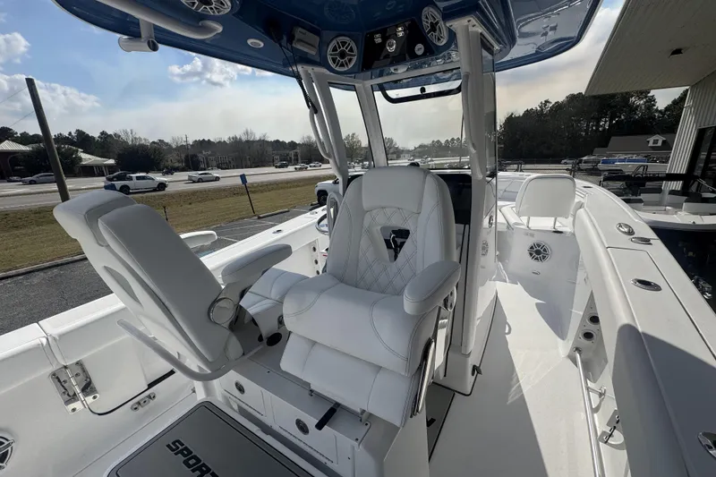 Slide: The Image of 2026 Sportsman Heritage 261 Center Console boat interior with white seating and modern controls. - 23