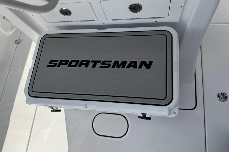 Slide: The Image of 2026 Sportsman Heritage 261 Center Console boat deck with branded storage compartment. - 24