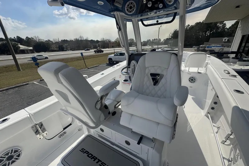 Slide: The Image of 2026 Sportsman Heritage 261 Center Console boat interior with white seating and modern controls. - 27