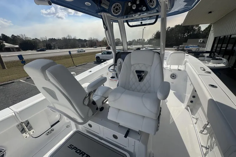 Slide: The Image of 2026 Sportsman Heritage 261 Center Console boat interior with white seating and modern controls. - 28
