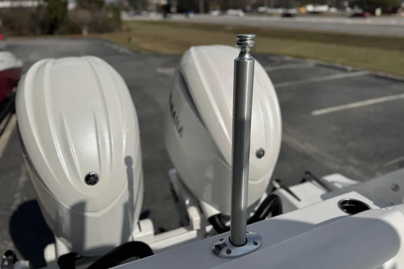 Slide: The Image of 2026 Sportsman Heritage 261 Center Console with dual outboard motors in a parking lot. - 29