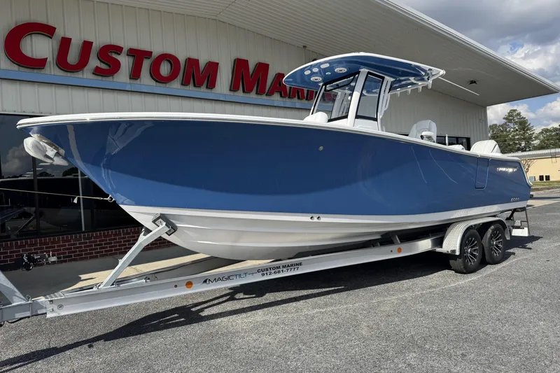 Slide: The Image of 2026 Sportsman Heritage 261 Center Console boat on trailer at Custom Marine dealership. - 4