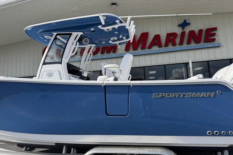 Slide: The Image of 2026 Sportsman Heritage 261 Center Console boat displayed at Custom Marine dealership. - 6