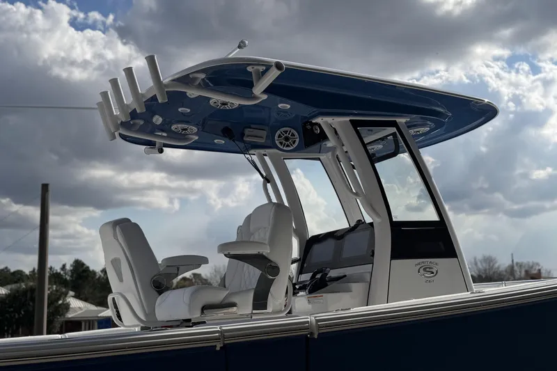 Slide: The Image of 2026 Sportsman Heritage 261 Center Console boat under cloudy sky. - 9