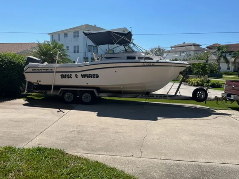 The Image of Grady-White Voyager 2000 on trailer in sunny driveway. - 0