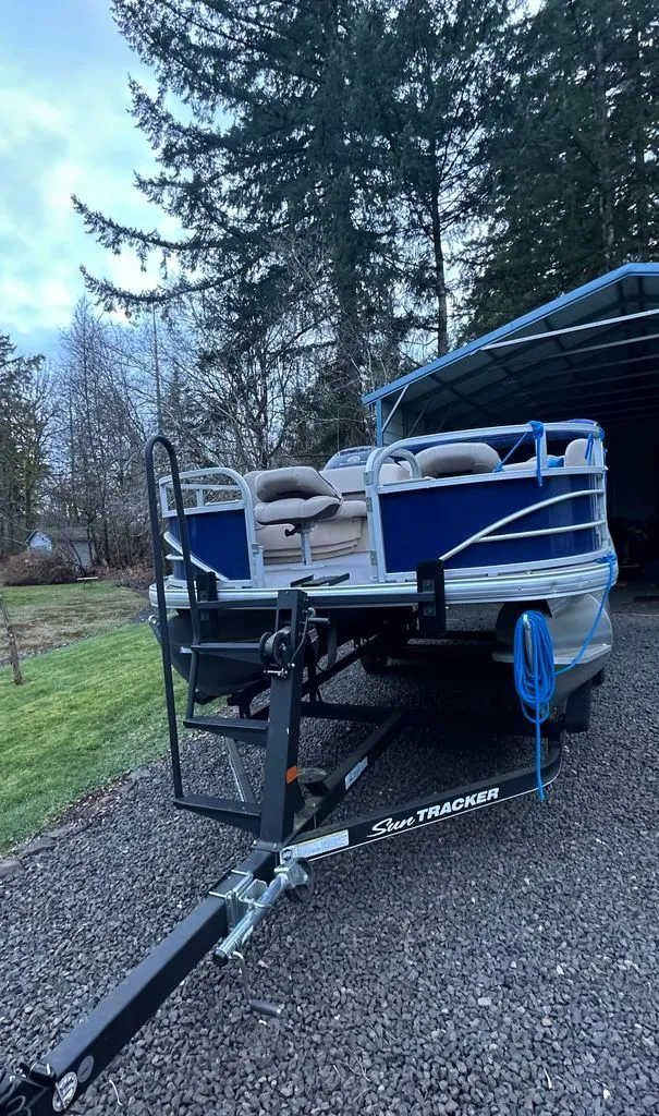 Slide: The Image of 2017 Sun Tracker FISHIN BARGE on trailer parked outdoors. - 2