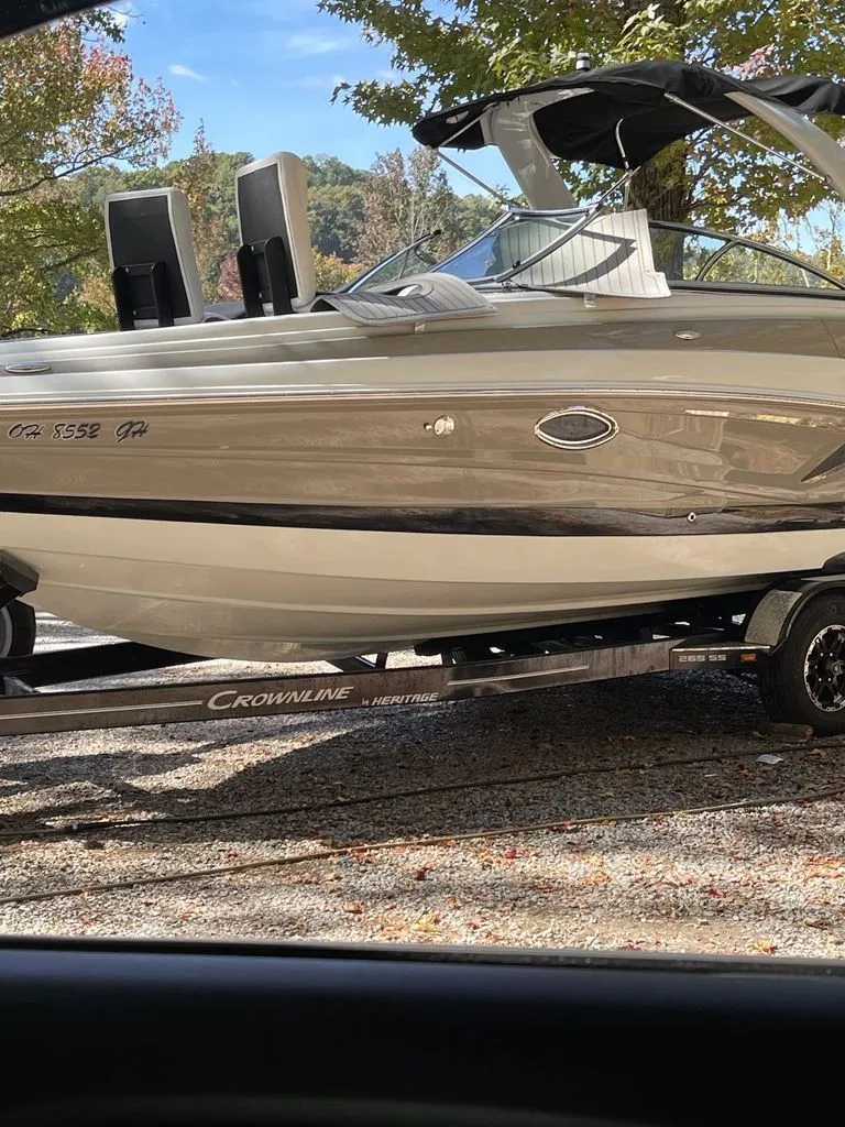 Slide: The Image of 2022 Crownline 265 SS boat on trailer outdoors. - 12