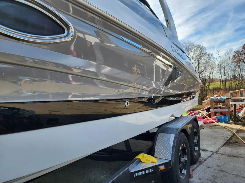 Slide: The Image of 2022 Crownline 265 SS boat on trailer outdoors. - 13