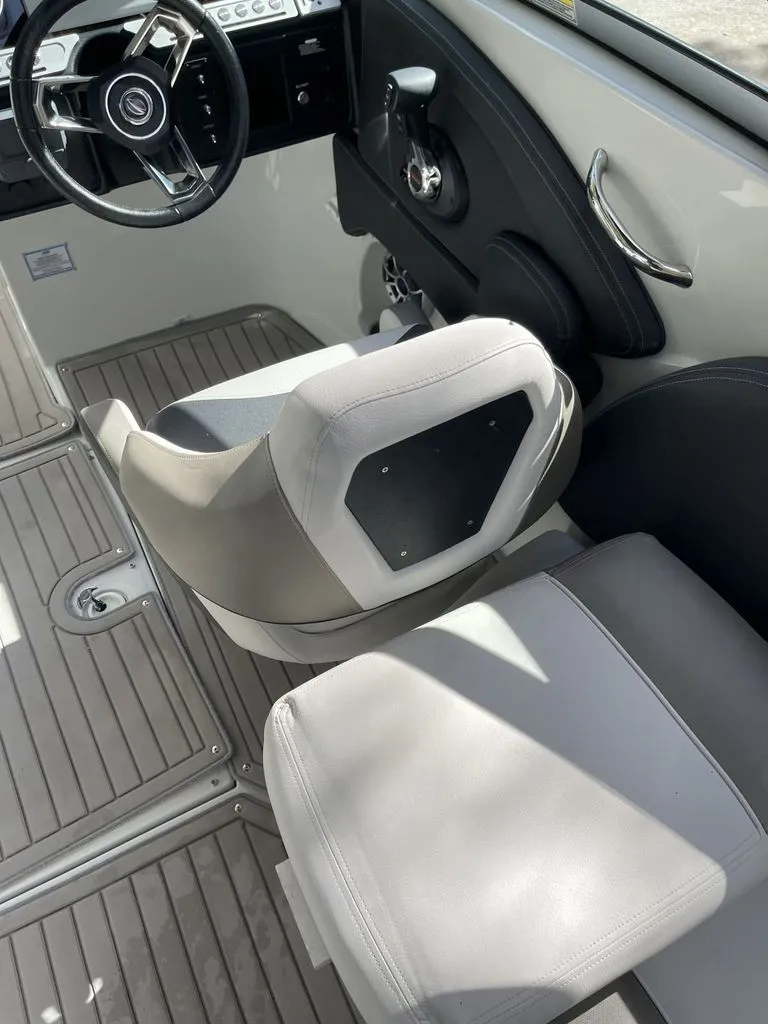 Slide: The Image of Interior of 2022 Crownline 265 SS boat with steering wheel and seat. - 3