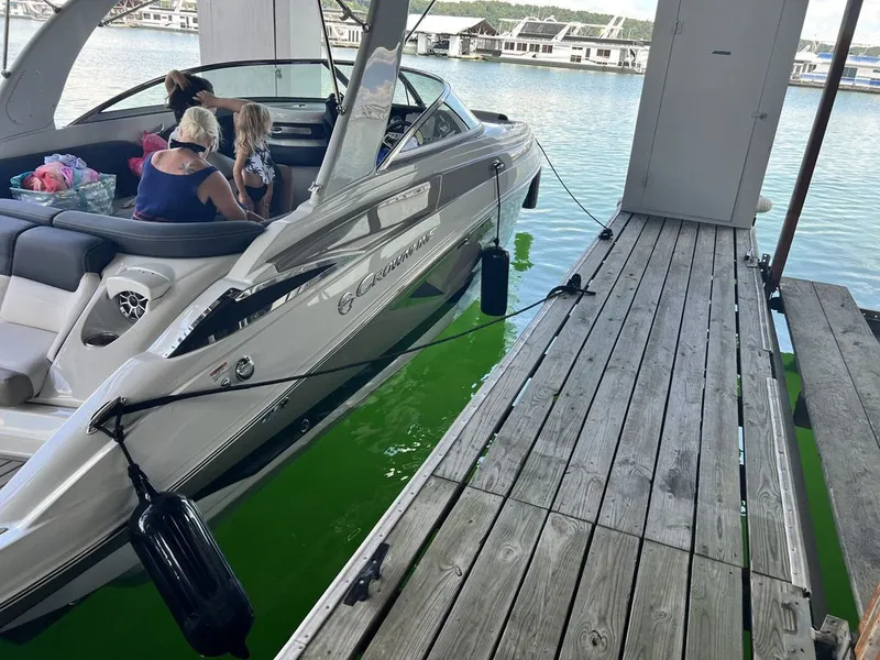 Slide: The Image of 2022 Crownline 265 SS boat docked with passengers. - 7