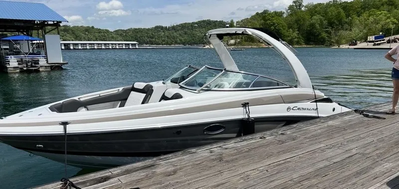 Slide: The Image of 2022 Crownline 265 SS boat docked at lakeside. - 9