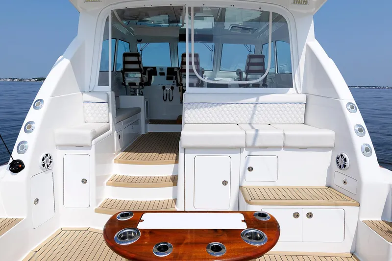Slide: The Image of 2023 Henriques 42 Express Hardtop boat interior with seating and fishing amenities. - 19