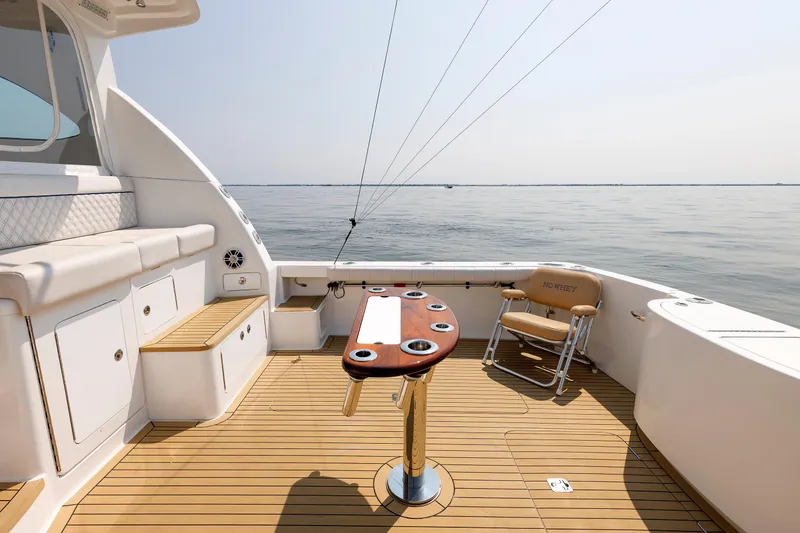 Slide: The Image of 2023 Henriques 42 Express Hardtop boat deck with seating and ocean view. - 23
